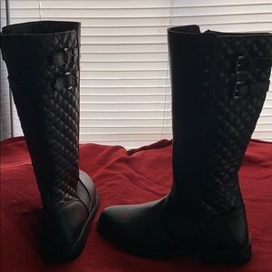 Black, knee high quilted boots.